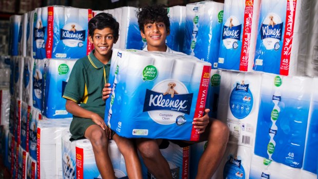 Nathan Mahaarachchi, 11, and Thevin Mahaarachchi, 14, with one of Costco's most popular products: Kleenex bath tissue.