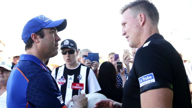 Meeting of minds: Brad Scott chats with Collingwood coach Nathan Buckley before the NAB Challenge match at Robertson Oval.