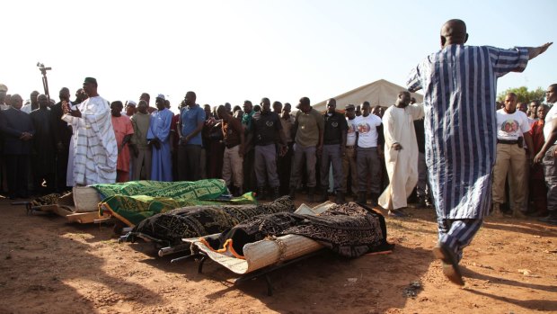 The remains of people slain by gunmen during recent attacks in Mali's capital are laid out during a funeral in Bamako.