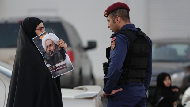A Bahraini protester holds up a picture of Saudi Shiite cleric Sheikh Nimr Baqir al-Nimr confronting a riot police officer in Bahrain in January 2016. Qatar is out of step with its neighbours on the question of Iran, which has championed Shiite rights in Saudi Arabia, Yemen and Bahrain.