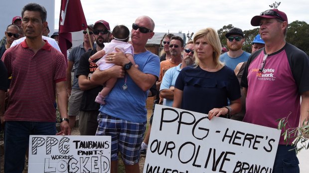 Some of the PPG employees who have been locked out of work since August attend a meeting in front of the company's premises in Villawood.  