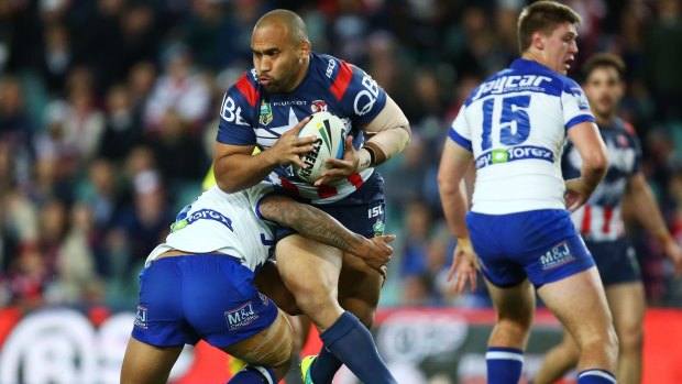 Wrapped up: Roosters forward Sam Moa takes on the defence.