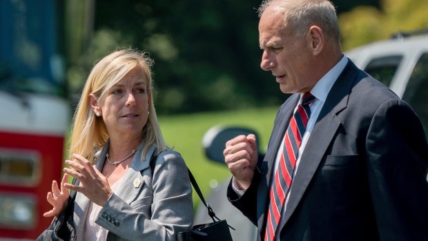 Then White House Chief of Staff John Kelly and deputy Kirstjen Nielsen walk across the South Lawn of the White House.