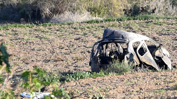 The wreckage of the car of investigative journalist Daphne Caruana Galizia lies next to a road in the town of Mosta, Malta.