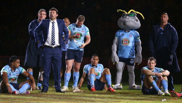 Coach Laurie Daley and his dejected Blues after losing game three at Suncorp Stadium.