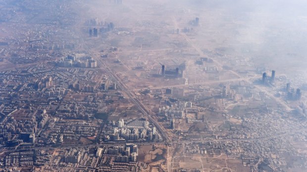 Choked: Smog envelops buildings on the outskirts of Delhi.  