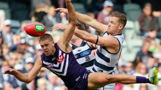 Joel Selwood and Stephen Hill battle in a marking contest.