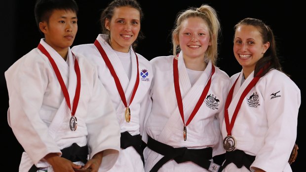 Chloe Rayner (second right) and Amy Meyer (right) from Australia pose with their bronze medals.
