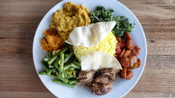 Load up your plate with a selection of curries, rice, vegies and other dishes.