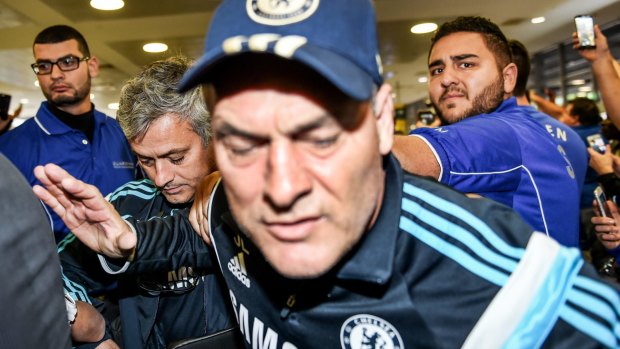 Star power: Chelsea manager Jose Mourinho edges past fans at Sydney Airport.