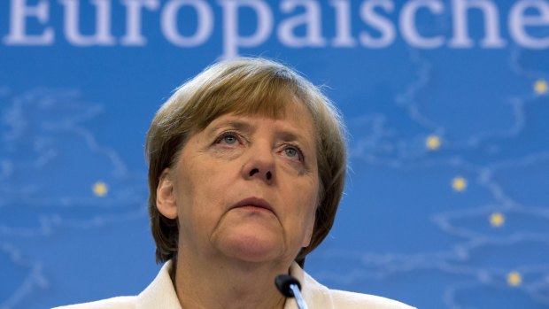 German Chancellor Angela Merkel listens to questions during a news conference at the end of a euro zone leaders summit in Brussels.