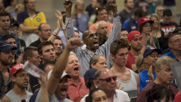 Attendees cheer as Donald Trump speaks during a campaign event in Phoenix, Arizona.