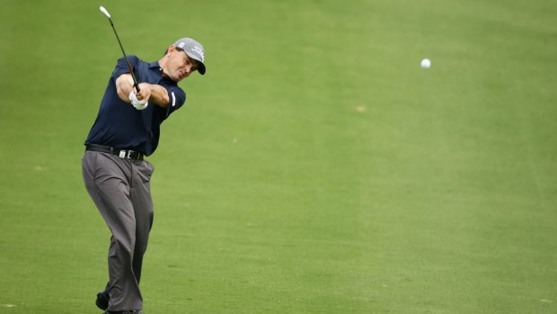 UK entry: Greg Chalmers plays his approach shot on the 13th during day four of the Australian Open.