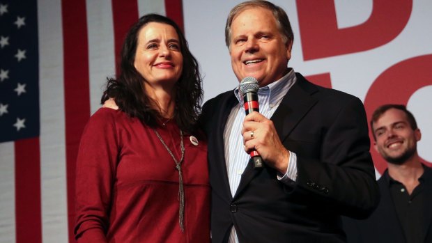 Democratic candidate for US Senate Doug Jones stands with his wife Louise as he speaks to supporters at a rally on the even of the election. 