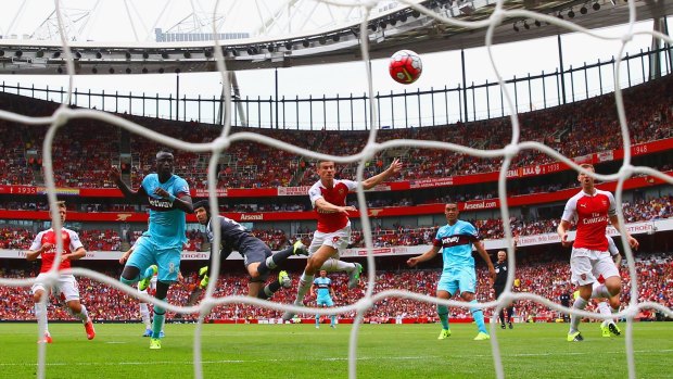First blood: Arsenal keeper Petr Cech fails to punch clear the ball as West Ham's Cheikhou Kouyate heads in the opening goal at the Emirates Stadium.