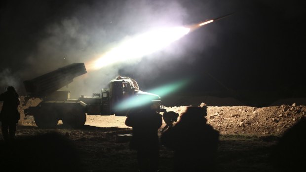 Soldiers from the Syrian army fire a rocket at Islamic State group positions in the province of Raqqa.