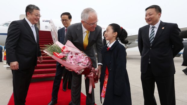Prime Minister Malcolm Turnbull was presented with flowers on arrival in Shanghai.