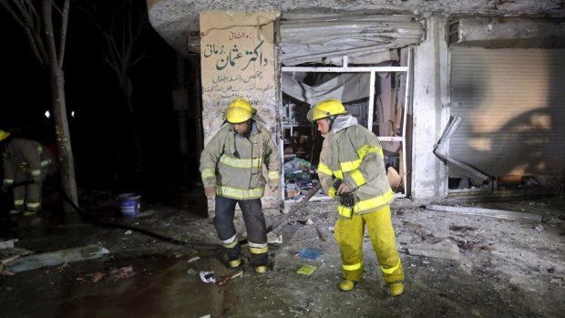 Firefighters at the scene of Sunday's suicide attack in Kabul.