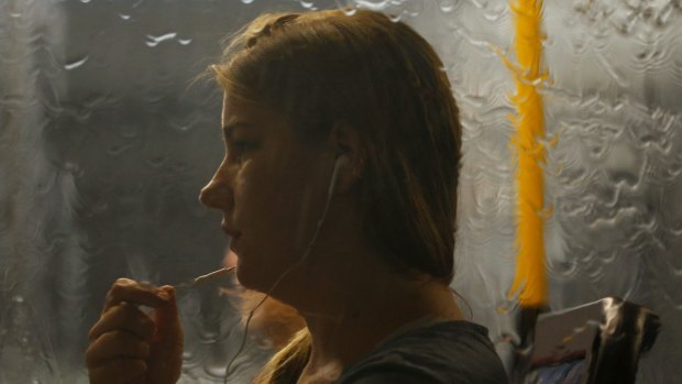 A woman rides a bus during a severe thunderstorm in Sydney on February 7.