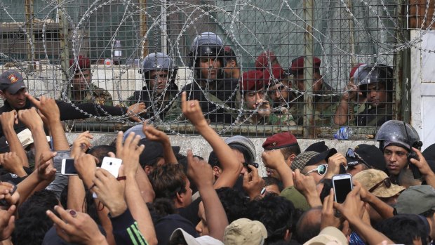 Security forces try to stop supporters of Shiite cleric Muqtada al-Sadr from storming parliament in Baghdad's Green Zone.