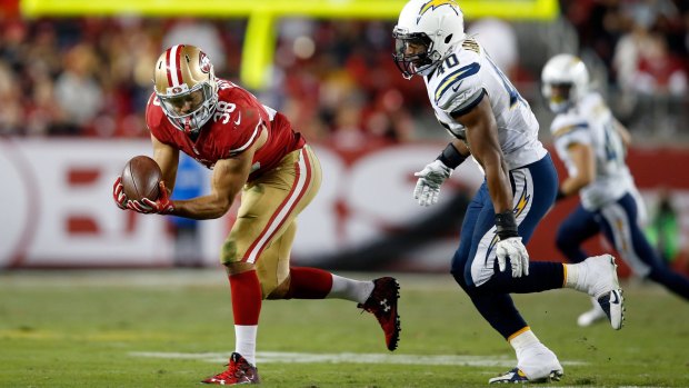 Waiting game: Hayne gathers the ball in against the Chargers.