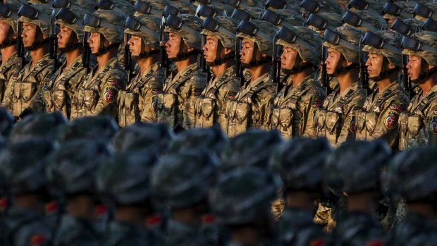 Chinese soldiers march past Tiananmen Square.