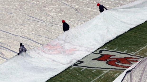 Ground crew at Kansas City's Arrowhead Stadium, where an ice storm is due to hit.