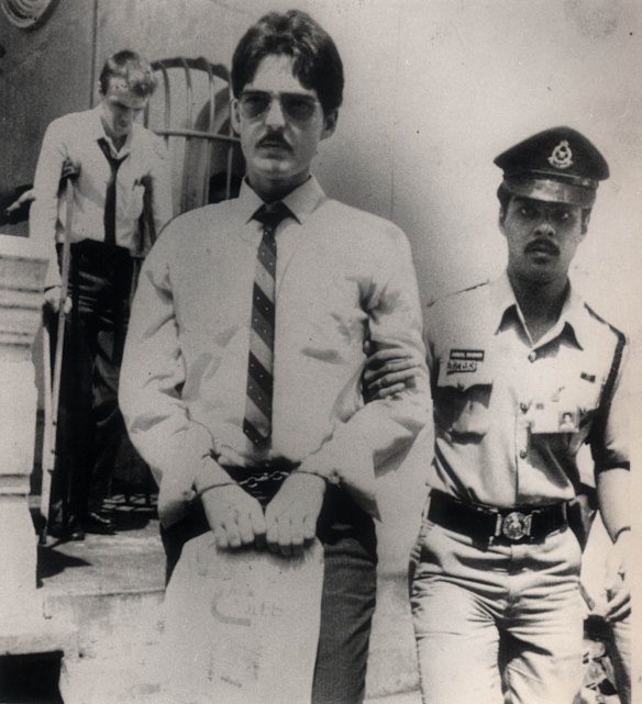 Brian Geoffrey Chambers, foreground, and Kevin Barlow are led away from a Malaysian court where they were facing the death penalty for drug trafficking in July 1986.