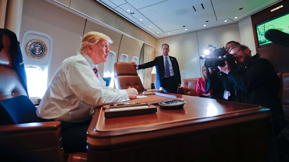 President Donald Trump at his desk on Air Force One on Thursday.