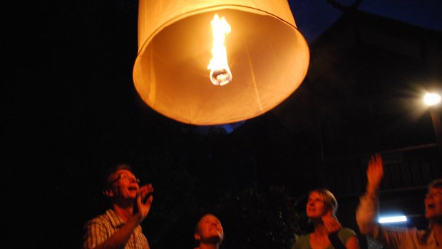 Launching a khum loy lantern.