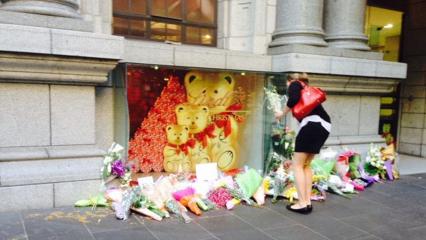 Danielle Forbes-Pryer leaves flowers at the Lindt Cafe in Collins Street.