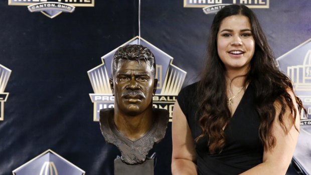 Real risks: Sydney Seau, the daughter of former NFL player Junior Seau, poses with a bust of her father, whose brain was riddled with CTE. 