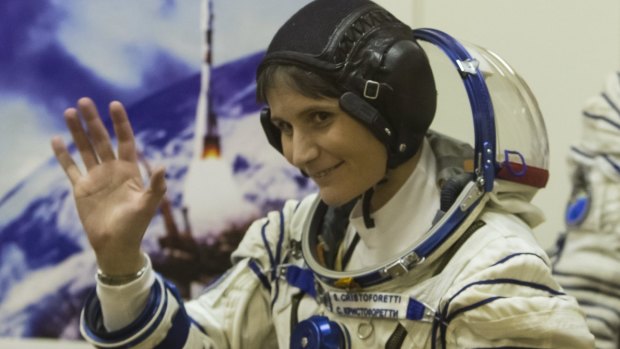 In orbit: Samantha Cristoforetti, of Italy, waves after donning her space suit. 