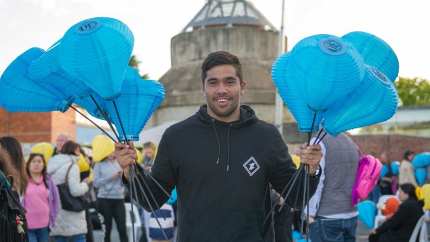 Jarrad Butler Carries 2 fists full of the Blue Lanterns friends family and the 1000s of supporters at the Canberra Leukaemia Foundation Light the Night walk to help more Australians beat blood cancer through research and support Photo Jay Cronan