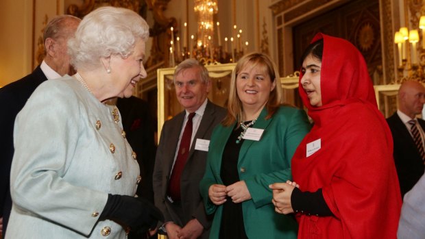 Britain's Queen Elizabeth II meets Malala Yousafzai during a reception for youth, education and the Commonwealth at Buckingham Palace, London, in October, 2013.