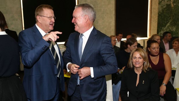 AOC President John Coates speaks to Jack Rush, QC, as Danni Roche looks on, during the Australian Olympic Committee Annual General Meeting on Saturday.