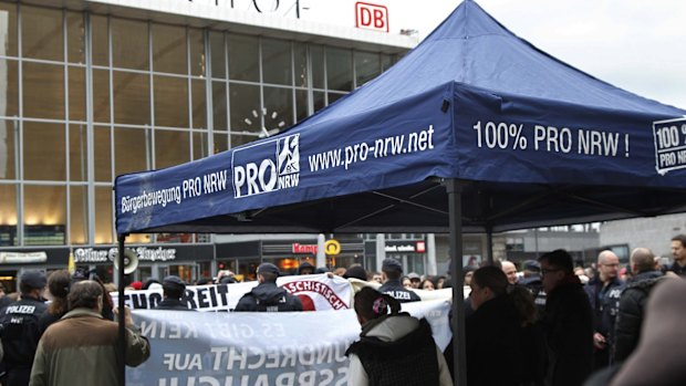 Protesters of the right-wing  PRO NRW party, front, and counter-demonstrators, rear,  stand in front of the main railway station in Cologne.