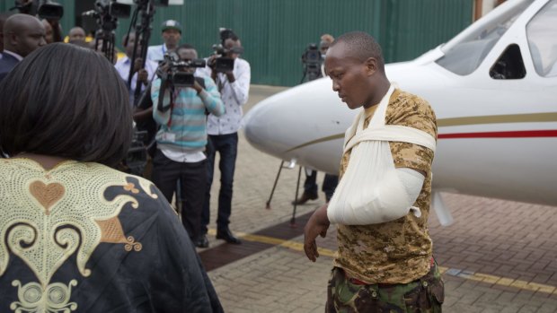 A Kenyan soldier, who Kenya Defence Forces said was injured in the attack by al-Shabab in Somalia earlier this week, walks from the plane to a waiting ambulance after being airlifted back to Nairobi.