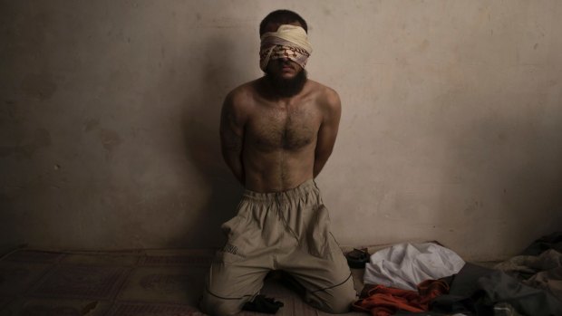 A suspected Islamic State fighter is held in a basement by Iraqi forces.
