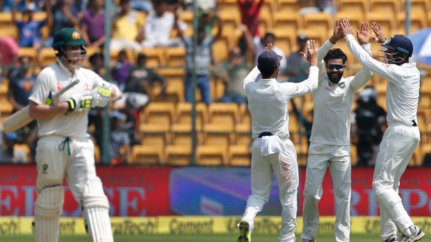 Fightback: India's Ravindra Jadeja celebrates the first-innings dismissal of Steve Smith in Bangalore.
