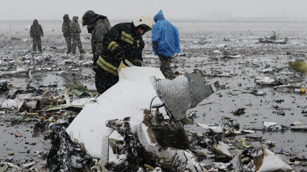 Russian Emergency Ministry employees investigate the wreckage of the crashed plane at Rostov-on-Don Airport.