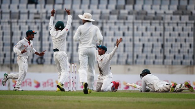 Bangladesh's players appeal to dismiss Australia's Usman Khawaja late on day one of the first Test in Dhaka.