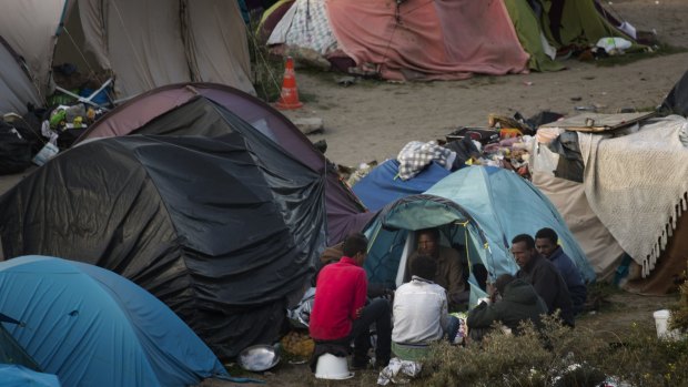 Migrants at their camp set near Calais, northern France.