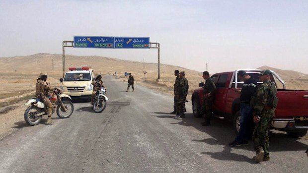 Syrian government soldiers at the entrance of Palmyra on Thursday. 