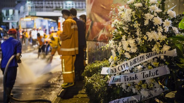 A bouquet of flowers is placed in front of the explosion site in the centre of Jakarta.