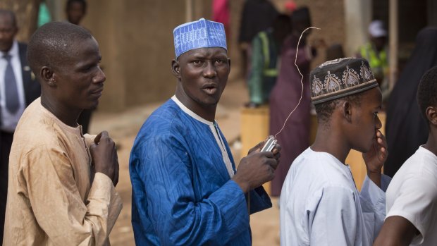 Nigerian men listen to the latest election news on a portable radio in Daura, the home town of opposition candidate Muhammadu Buhari. 