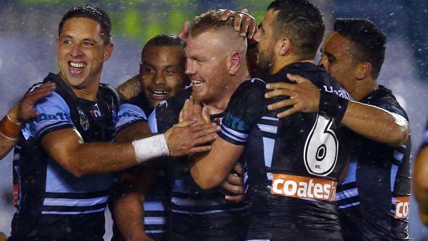 Wet and wild: The Sharks celebrate Luke Lewis' try on Monday night.