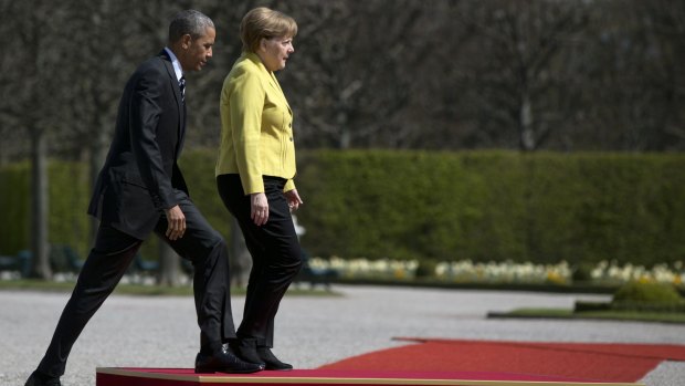 US President Barack Obama and German Chancellor Angela Merkel take their position during an arrival ceremony at Schloss Herrenhausen in Hanover, Germany.