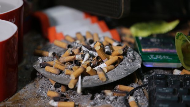 Cigarettes overflow from an ashtray in the home of suspected child webcam cybersex operator, David Timothy Deakin, in the Philippines.