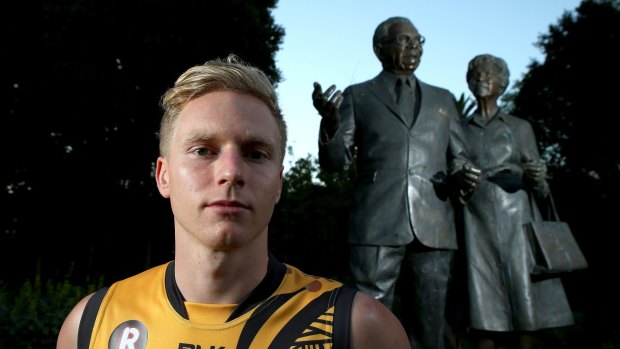Nathan Drummond in front of a statue of Sir Doug Nicholls.